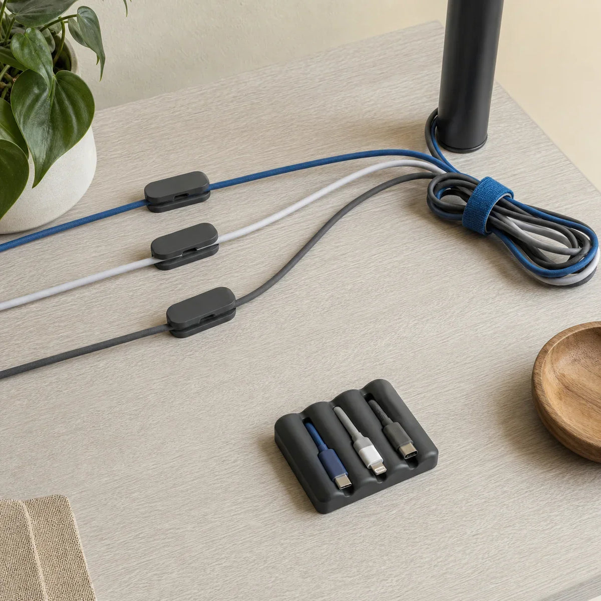 Three cable paths organized with clips, reusable ties, and a weighted desktop anchor